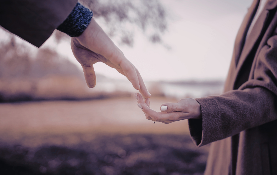 One hand reaching out to touch another