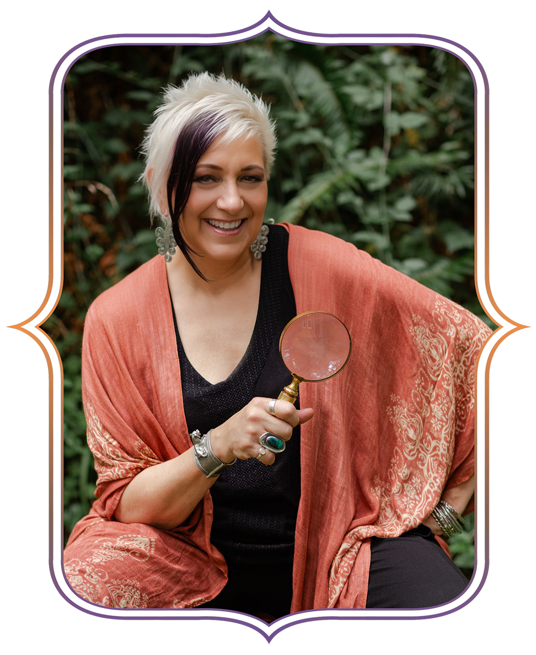 Leslie Zemenek sitting, holding a magnifying glass